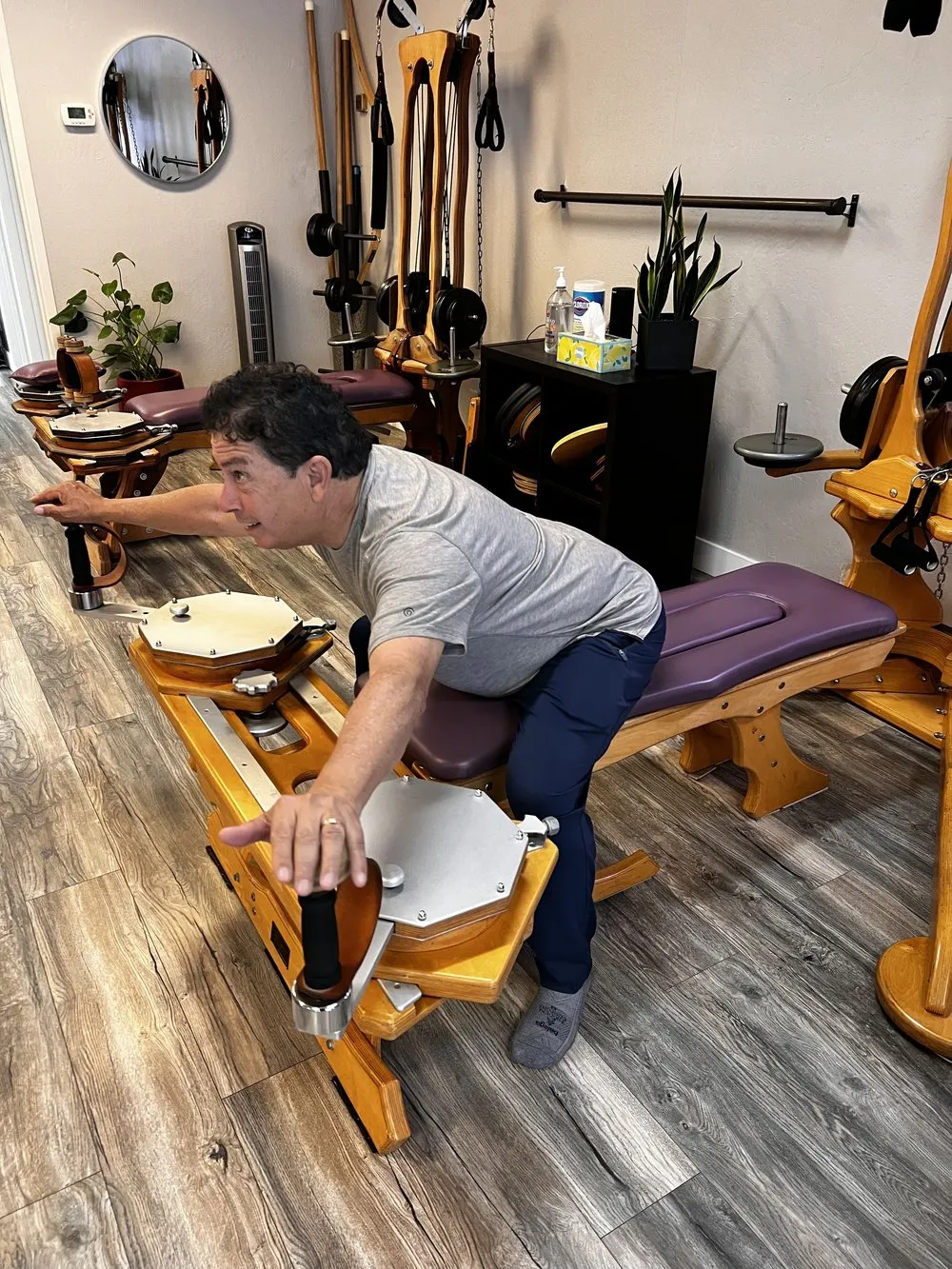 A student on the wooden GYROTONIC tower moving through a spiral